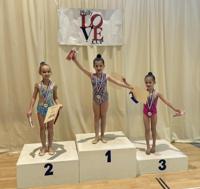 Three Phoenix gymnasts on the winners' podium at the Philly Love Cup
