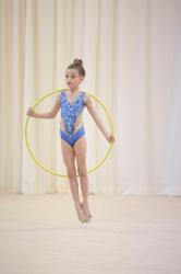 Gymnast jumping through her hoop during a routine