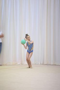 Gymnast presenting her ball at the start of a floor routine